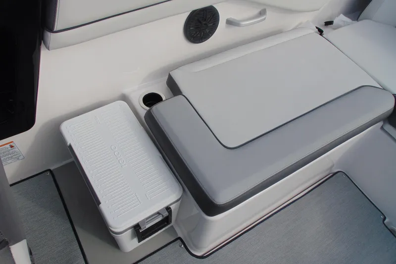 Slide: The Image of 2026 Yamaha Boats AR250 interior seating with integrated cooler and cup holder. - 15