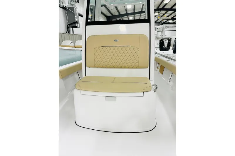 Slide: The Image of 2026 Sportsman Masters 247 Bay Boat interior with tan cushioned seating and modern design. - 10