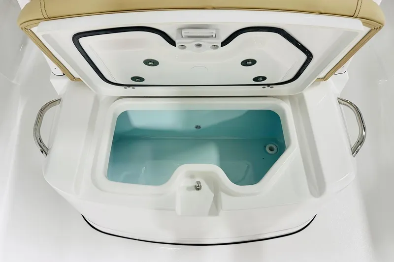 Slide: The Image of Livewell compartment on 2026 Sportsman Masters 247 Bay Boat, open with blue interior. - 11