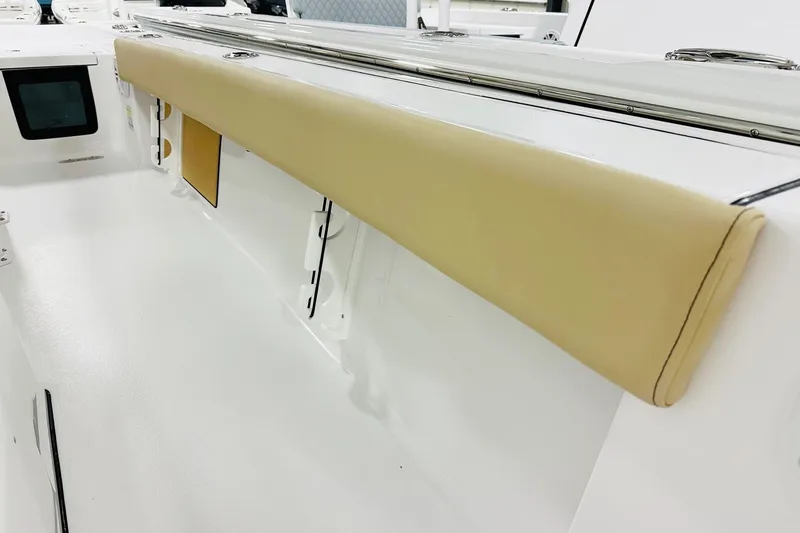 Slide: The Image of 2026 Sportsman Masters 247 Bay Boat interior with cushioned side panel. - 12