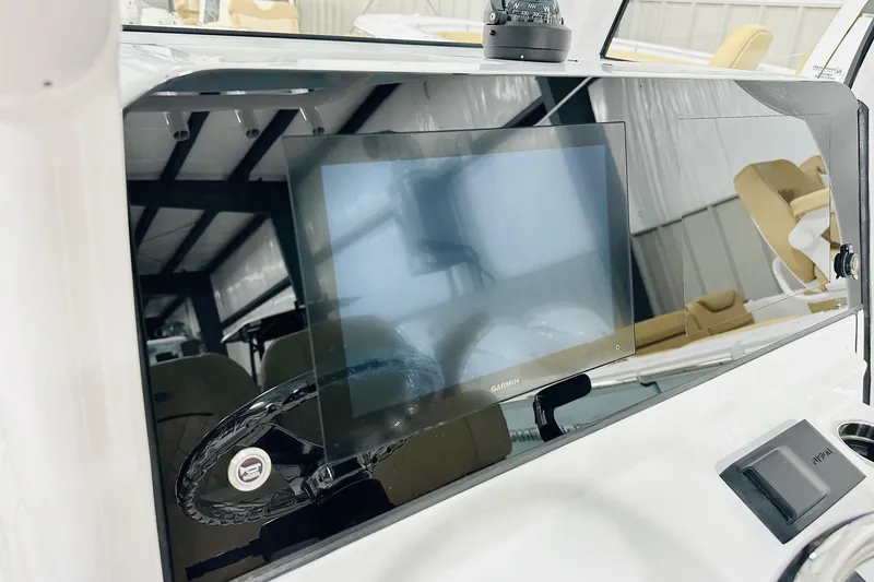 Slide: The Image of 2026 Sportsman Masters 247 Bay Boat dashboard with Garmin display and steering wheel. - 4