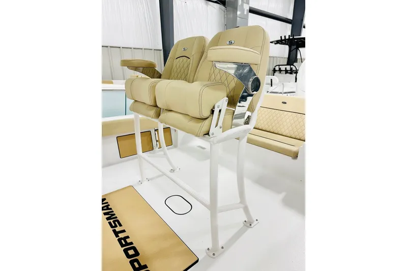Slide: The Image of 2026 Sportsman Masters 247 Bay Boat with beige cushioned seats and sleek design. - 5