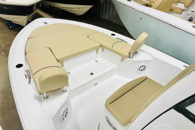 Slide: The Image of 2026 Sportsman Masters 247 Bay Boat interior with beige seating and white deck. - 8