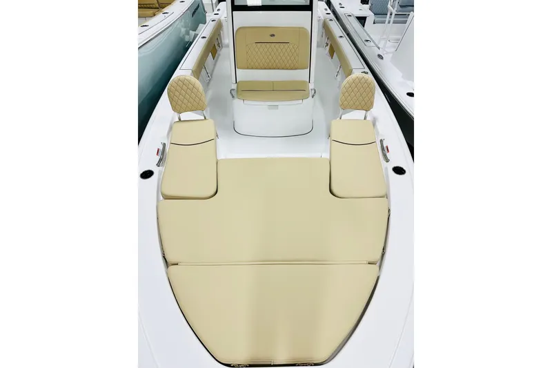 Slide: The Image of 2026 Sportsman Masters 247 Bay Boat interior with beige seating and modern design. - 9