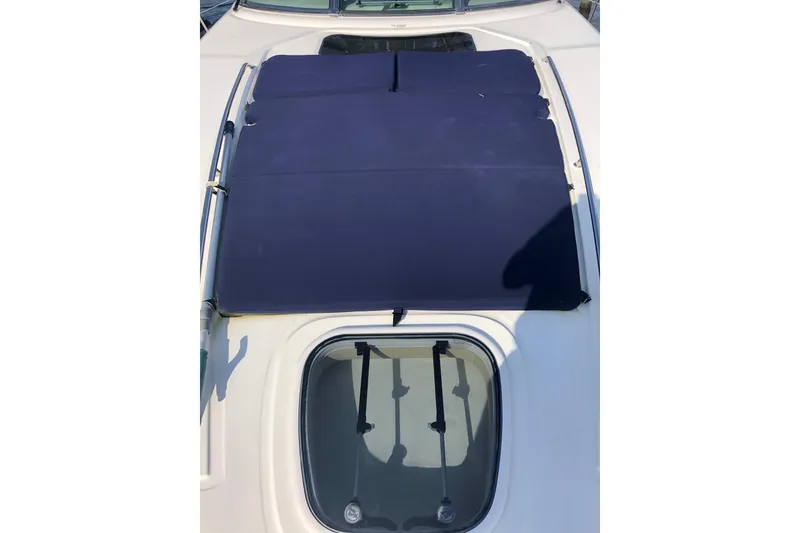 Slide: The Image of 2007 Sea Ray 40 Sundancer boat with blue sunshade and deck hatch. - 10