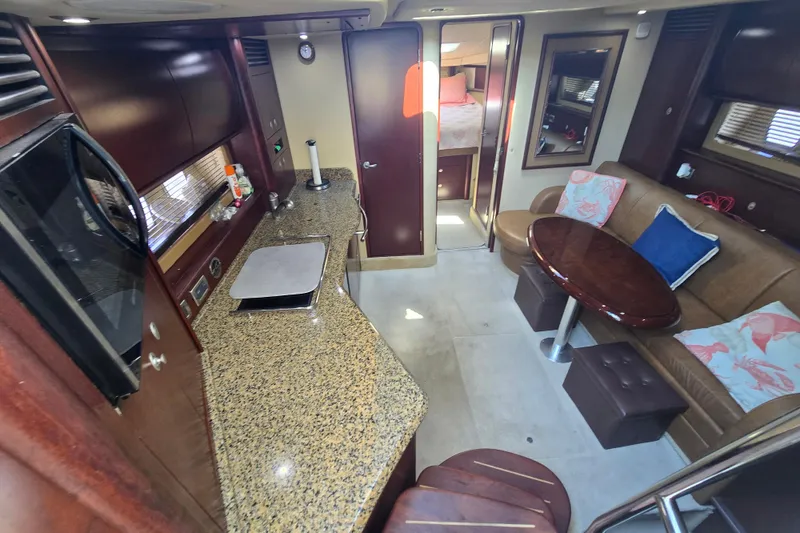 Slide: The Image of Luxurious interior of 2007 Sea Ray 40 Sundancer yacht with kitchen and seating area. - 12