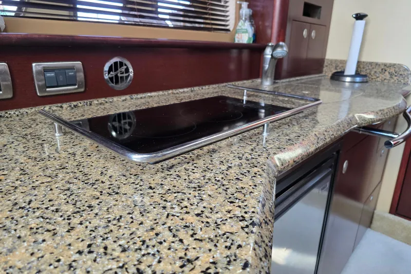 Slide: The Image of 2007 Sea Ray 40 Sundancer kitchen with granite countertop and modern appliances. - 15