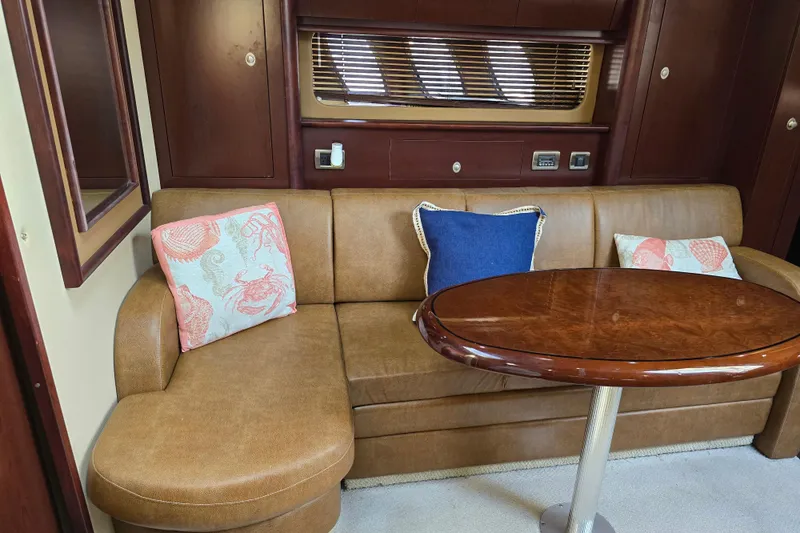 Slide: The Image of Luxurious 2007 Sea Ray 40 Sundancer interior with leather sofa and wooden table. - 18
