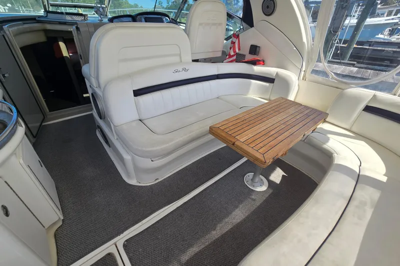 Slide: The Image of 2007 Sea Ray 40 Sundancer interior with white seating and wooden table. - 7
