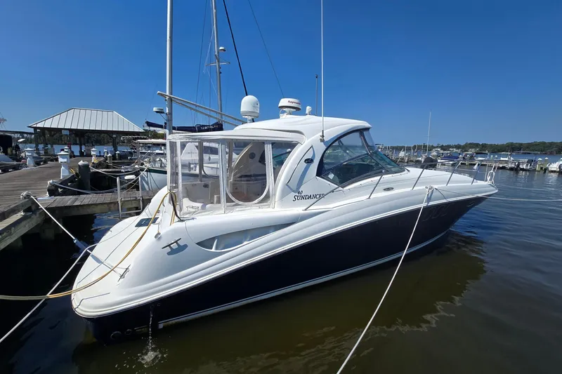 Slide: The Image of 2007 Sea Ray 40 Sundancer yacht docked at marina under clear blue sky. - 8