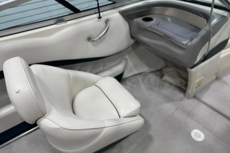 Slide: The Image of 1998 Crownline 202 BR boat interior with white seating and gray accents. - 11