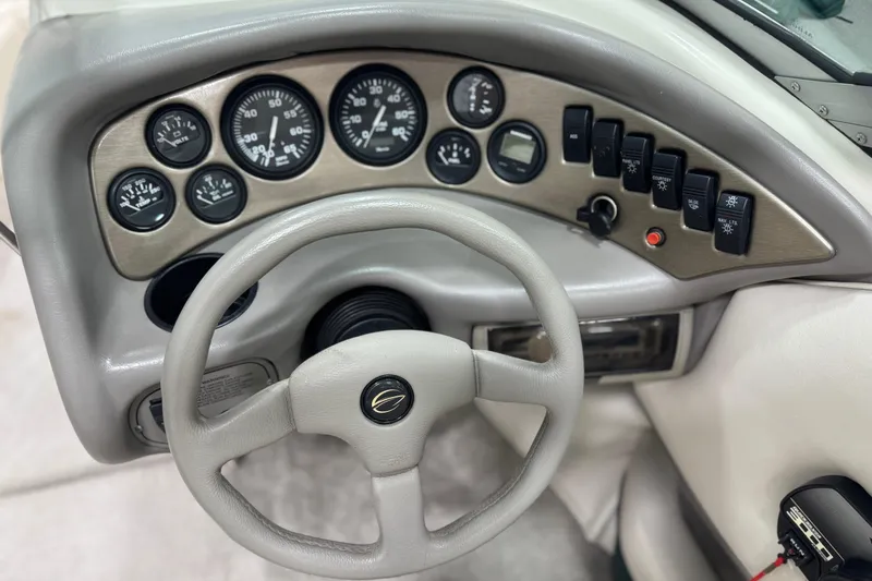 Slide: The Image of 1998 Crownline 202 BR boat dashboard with gauges and controls. - 13