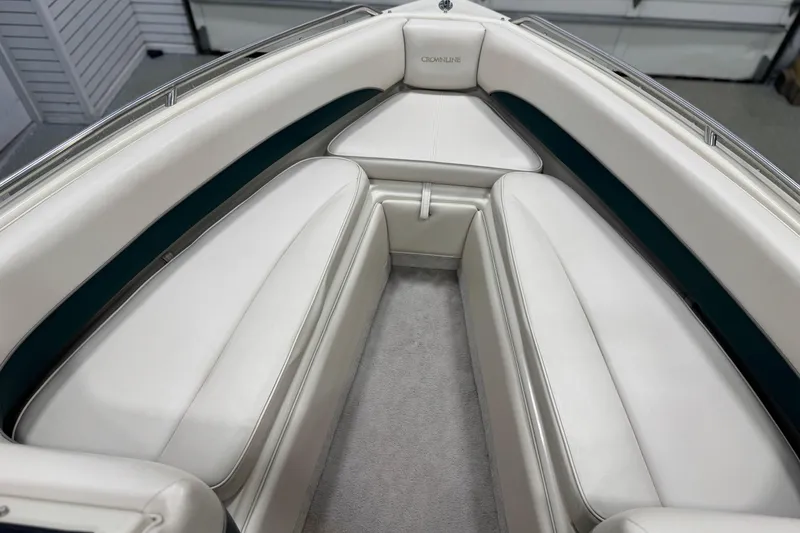 Slide: The Image of Interior of a 1998 Crownline 202 BR boat with white cushioned seating. - 16