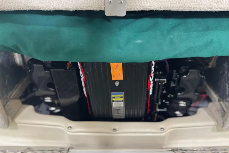 Slide: The Image of Engine compartment of a 1998 Crownline 202 BR boat, featuring a covered motor. - 18
