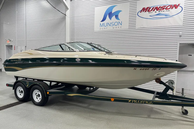 Slide: The Image of 1998 Crownline 202 BR boat on trailer in showroom, Munson Ski & Marine signage. - 3