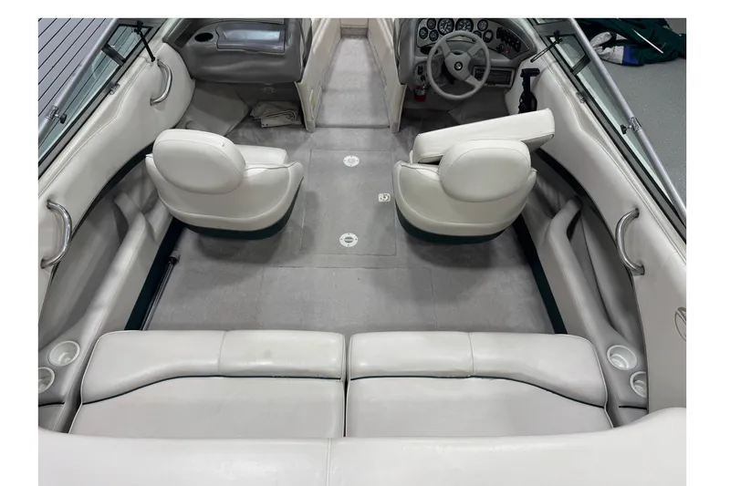 Slide: The Image of 1998 Crownline 202 BR boat interior with white seating and dashboard view. - 7