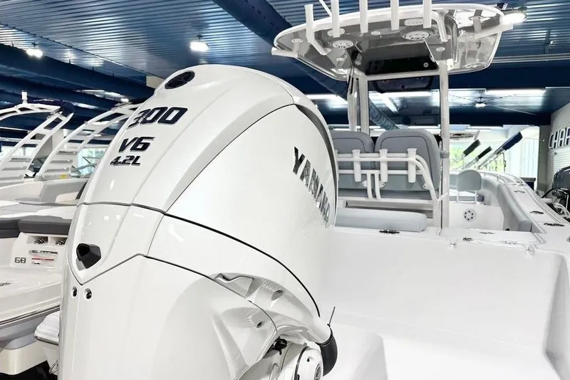 Slide: The Image of 2026 Sportsman Open 232 Center Console with Yamaha 300 V6 engine in showroom. - 14