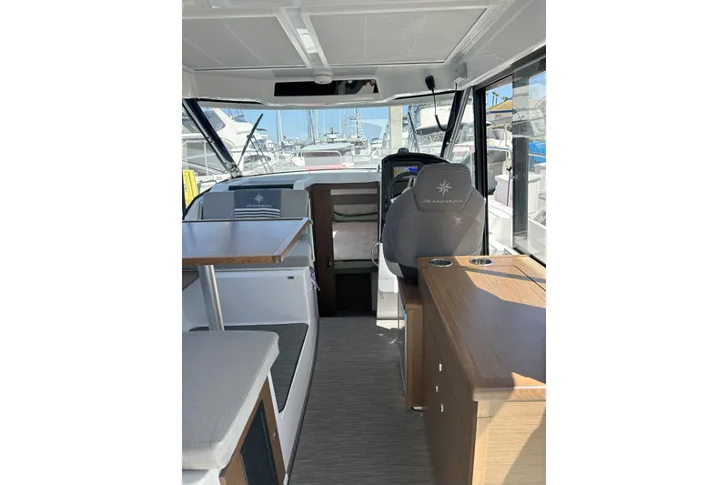 Slide: The Image of Interior of 2021 Jeanneau NC895 boat, featuring helm, seating, and modern design. - 10