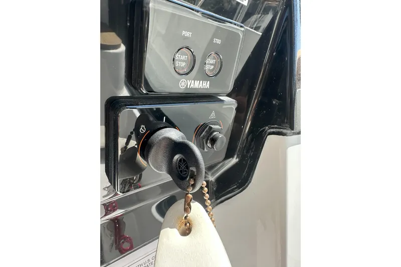 Slide: The Image of Control panel of 2021 Jeanneau NC895 boat with Yamaha start/stop buttons and key ignition. - 16