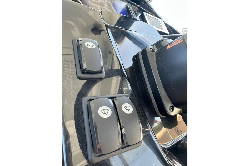 Slide: The Image of Control panel of 2021 Jeanneau NC895 boat with switches and buttons. - 21