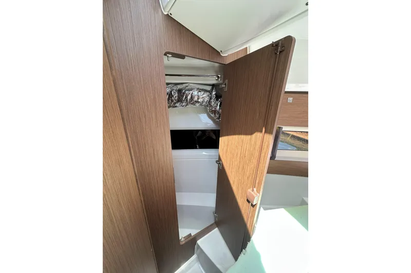 Slide: The Image of Interior view of 2021 Jeanneau NC895 boat, featuring a wooden door and modern design. - 33