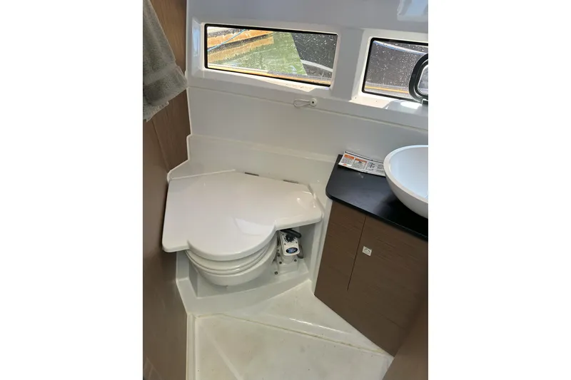 Slide: The Image of 2021 Jeanneau NC895 boat bathroom with compact toilet and sink. - 34