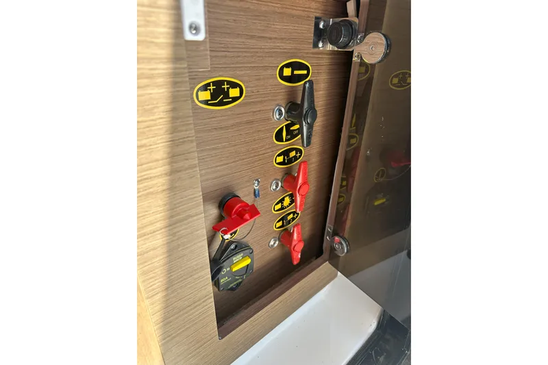 Slide: The Image of Control panel of 2021 Jeanneau NC895 boat with labeled switches and indicators. - 39