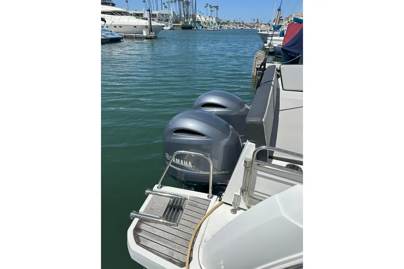 Slide: The Image of 2021 Jeanneau NC895 with Yamaha outboard engines docked in a marina. - 4