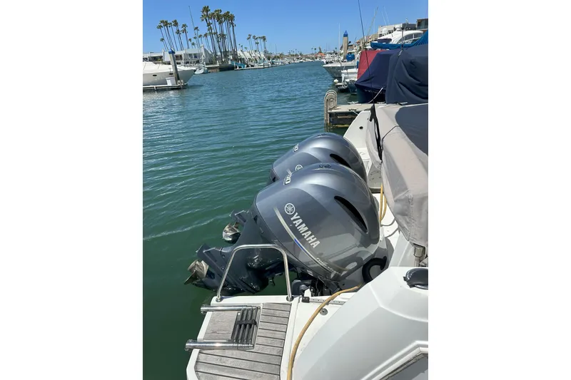 Slide: The Image of 2021 Jeanneau NC895 with twin Yamaha outboard engines docked in a marina. - 45