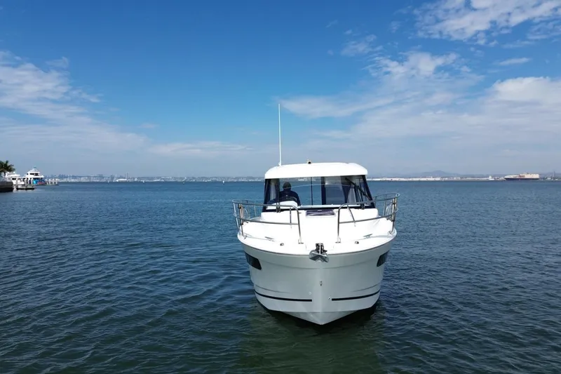 Slide: The Image of 2021 Jeanneau NC895 boat on calm water under a clear blue sky. - 47