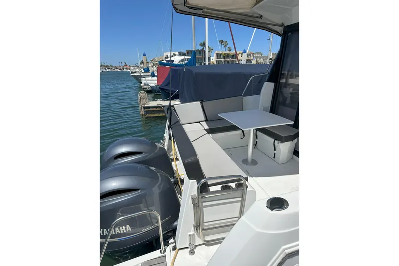 Slide: The Image of 2021 Jeanneau NC895 boat with Yamaha engines, docked at a marina. - 6