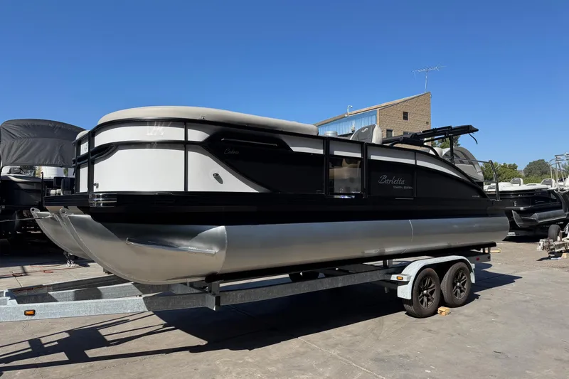 Slide: The Image of 2026 Barletta Cabrio 22UC pontoon boat on trailer under clear blue sky. - 12