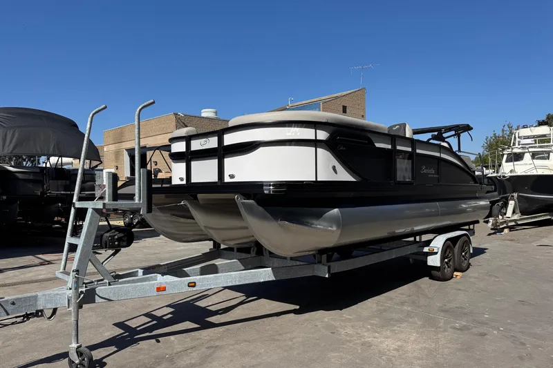 Slide: The Image of 2026 Barletta Cabrio 22UC pontoon boat on trailer, parked outdoors. - 13