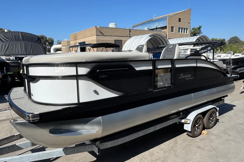 Slide: The Image of 2026 Barletta Cabrio 22UC pontoon boat on trailer, outdoor setting. - 14