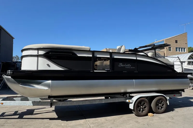 Slide: The Image of 2026 Barletta Cabrio 22UC pontoon boat on trailer, sleek design under clear blue sky. - 15