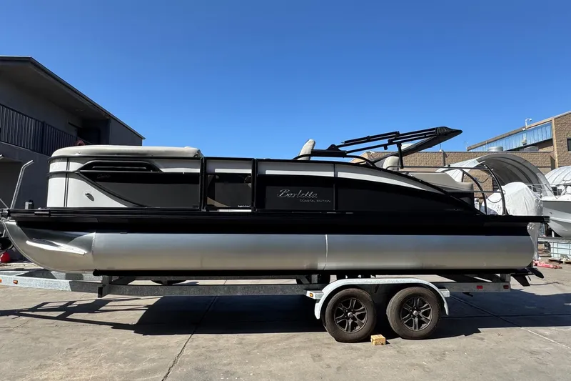 Slide: The Image of 2026 Barletta Cabrio 22UC pontoon boat on trailer, outdoor setting, clear blue sky. - 16
