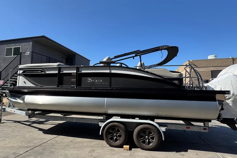 Slide: The Image of 2026 Barletta Cabrio 22UC pontoon boat on trailer, parked outdoors. - 17