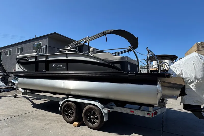 Slide: The Image of 2026 Barletta Cabrio 22UC pontoon boat on trailer under clear blue sky. - 18