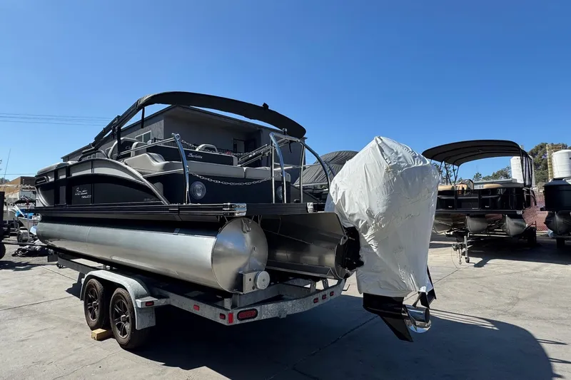 Slide: The Image of 2026 Barletta Cabrio 22UC pontoon boat on trailer under clear blue sky. - 19