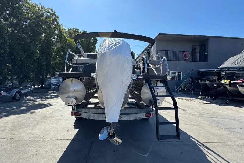 Slide: The Image of 2026 Barletta Cabrio 22UC pontoon boat on trailer, covered, in outdoor storage area. - 20