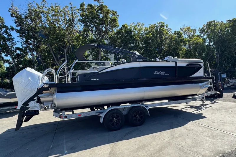 Slide: The Image of 2026 Barletta Cabrio 22UC pontoon boat on trailer, parked outdoors. - 24