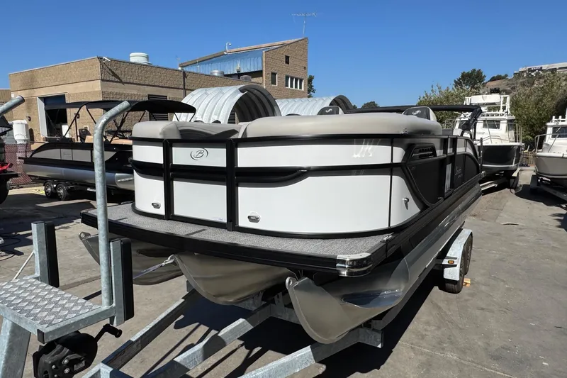 Slide: The Image of 2026 Barletta Cabrio 22UC pontoon boat on trailer, parked outdoors. - 30
