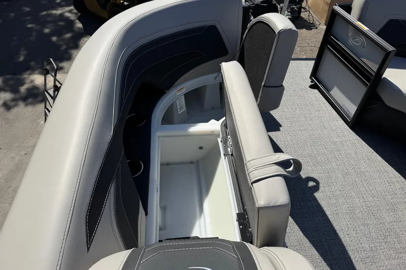 Slide: The Image of 2026 Barletta Cabrio 22UC boat interior with open storage compartment and cushioned seating. - 35