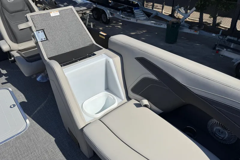 Slide: The Image of 2026 Barletta Cabrio 22UC boat interior with open storage compartment and seating. - 39