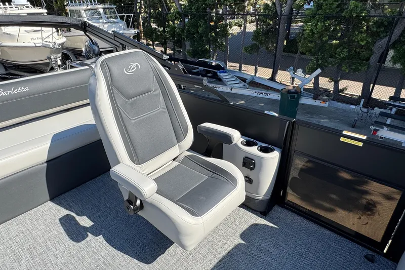 Slide: The Image of 2026 Barletta Cabrio 22UC boat interior with a comfortable captain's chair and cup holders. - 44