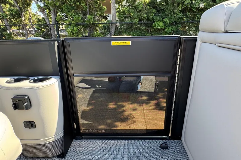 Slide: The Image of 2026 Barletta Cabrio 22UC boat interior with cup holders and safety gate. - 46