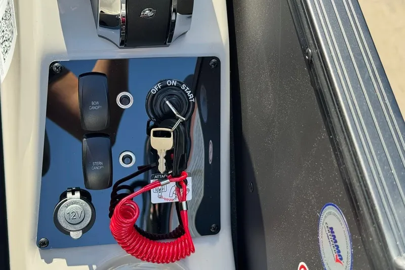 Slide: The Image of Control panel of 2026 Barletta Cabrio 22UC boat with ignition key and canopy switches. - 60