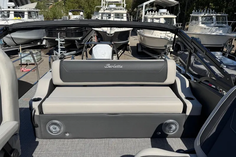 Slide: The Image of 2026 Barletta Cabrio 22UC boat interior with seating, surrounded by docked boats. - 62