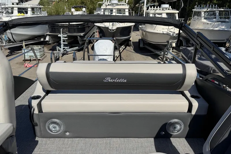 Slide: The Image of 2026 Barletta Cabrio 22UC boat interior with seating, surrounded by other boats. - 63