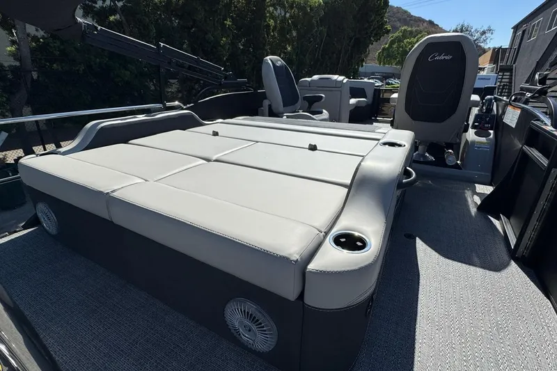 Slide: The Image of 2026 Barletta Cabrio 22UC pontoon boat interior with spacious seating and cup holders. - 65
